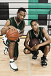 African basketball players with balls in gym