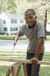 African boy sawing wood