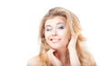 Winking smiling blonde woman holding hair with hands