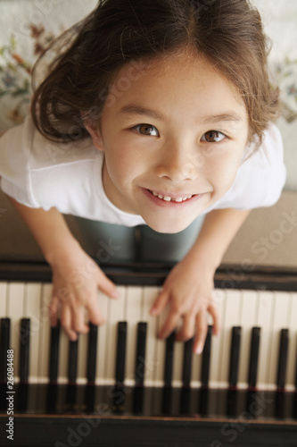 Photo: Mixed race girl playing piano Mixed race girl playing piano