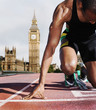 Black runner kneeling at starting block