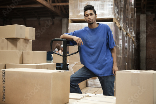 Photo: Black man standing in warehouse Black man standing in warehouse