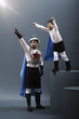Korean boy in superhero costume flying while father watches