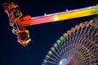 Ferris wheel and carnival ride at night. Motion blur Ferris wheel and carnival ride at night. Motion blur