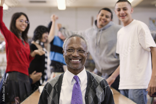 Photo: Librarian with cheering students in school library Librarian with cheering students in school library