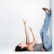 Pretty young woman lying on floor in a weird position
