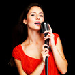 Young female star singer performing live in a concert