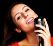Young female star singer singing with old mic
