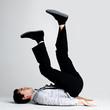 Upside down - Young guy lying on floor with legs up