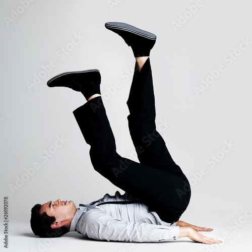 Photo: Upside down - Young guy lying on floor with legs up Upside down - Young guy lying on floor with legs up
