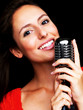 Beautiful young singer on dark background