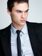 Thoughtful young male business executive looking away