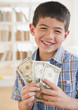 Mixed race boy holding money
