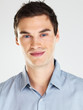 Handsome young man smiling against white background