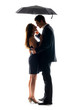 Romantic young couple standing under umbrella