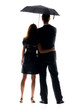 Rear view of a young couple holding an umbrella