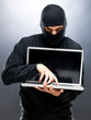 Cyber crime - Male thief stealing information from laptop