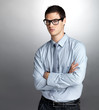 Handsome young businessman standing with folded hand
