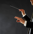Photo: Music conductor - Man directing with his baton in concert Music conductor - Man directing with his baton in concert