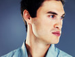 Handsome young man thinking against grey background