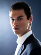 Smart young male entrepreneur looking serious