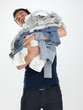 Washday - Young man looking tired doing laundry