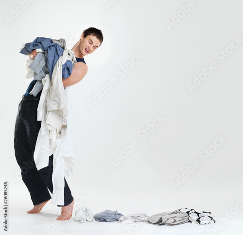 Photo: Bachelor life - Young man doing laundry Bachelor life - Young man doing laundry
