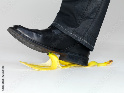 Foto: Business risk concept - Man stepping on banana peel Business risk concept - Man stepping on banana peel