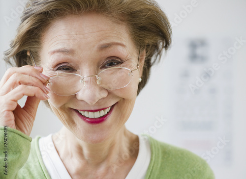 Photo: Japanese woman holding eyeglasses Japanese woman holding eyeglasses