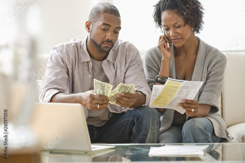 Photo: Black couple paying bills Black couple paying bills