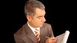 Businessman writing on notepad, black background