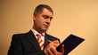 Businessman writing document on clipboard