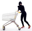 female thief in balaclava with shopping cart