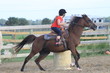 young girl barrel racing