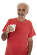Elderly man holding glass of milk