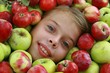 Smiling girl in apples mass