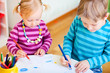 Brother and sister drawing in their room