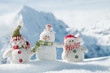 Happy snowmans in mountain
