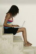 Photo: Female sitting on stairs and working on laptpo Female sitting on stairs and working on laptpo