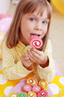 Cute child eating candies