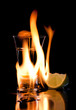 Flaming vodca, and lime over black Flaming vodca, and lime over black