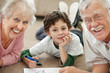 Photo: Old couple with their grandson making drawing Old couple with their grandson making drawing