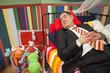 Mature man sleeping in children's bed Mature man sleeping in children's bed
