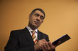 Businessman writing document on clipboard