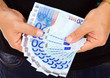 man hands whith euro bills, studio shot