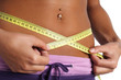 woman measure her waist belly by metre-stick woman measure her waist belly by metre-stick