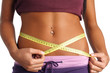 woman measure her waist belly by metre-stick woman measure her waist belly by metre-stick