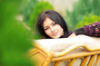 Young Woman Relaxing on the Sofa In Garden