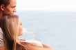 Young loving couple looking at a beautiful seaview in the window Young loving couple looking at a beautiful seaview in the window