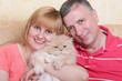 A cute family enjoying their life with a fluffy big cat A cute family enjoying their life with a fluffy big cat